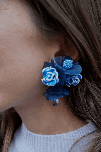 Pendientes bordados azules con diseño floral y cuentas de vidrio de origen japonés, en modelo, marca Uchaworld.